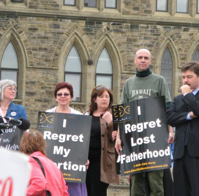 Hugh holding abortion sign, Silent No More, Canadian Parliament